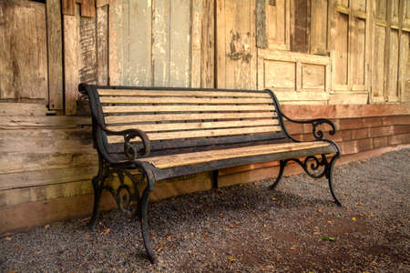The vintage bench in front of the Old wood wall background. retro style for backgroundの写真素材