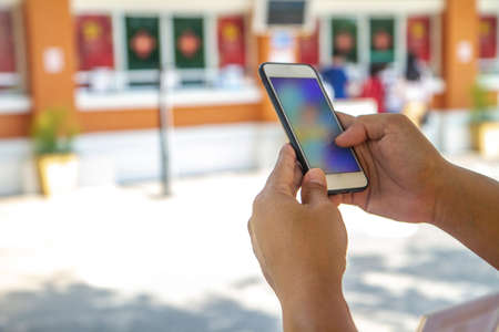 Man uses his Mobile Phone outdoor, technology conceptの写真素材