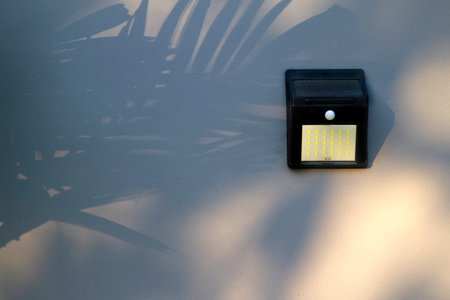copy space of Solar-powered motion sensor light isolated on cement or concrete wall background,