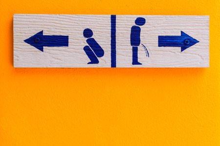 wood toilet sign on cement wallの写真素材