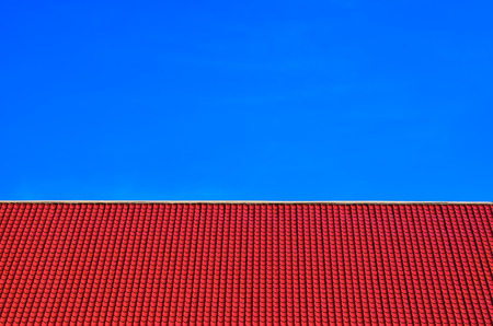 Red tiles roof on clear blue sky backgroundの写真素材
