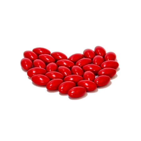 RED pills medicine heart shape on white backgroundの写真素材