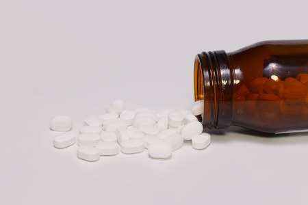 Pour a bottle of white pillsの写真素材