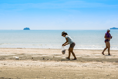 Krabi, Thailand - December 01, 2014   Tourists, garbage on the Ao Nang beach. by other tourist with a litter visitors irresponsible. Ao Nang beach is one of the world most beautiful beaches.のeditorial素材
