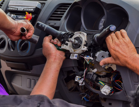 Repairman is Repairing Car steering wheel lock by hammer