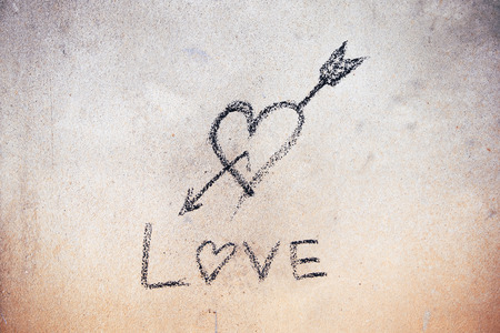 Written love sign with cinder on cement wallの写真素材