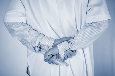 Doctor hide behind syringe on back ,holding in  hands. Medical concept.