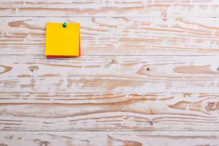 sticky note on wood board, empty space for textの写真素材