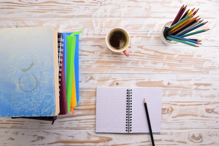 Coffee with notepad and pencil on wood table ,top viewの写真素材