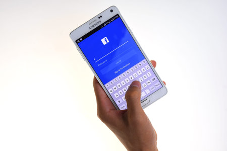 LOEI, THAILAND - JULY 02, 2015:  A man trying to log in Facebook application. Facebook.com is most...
