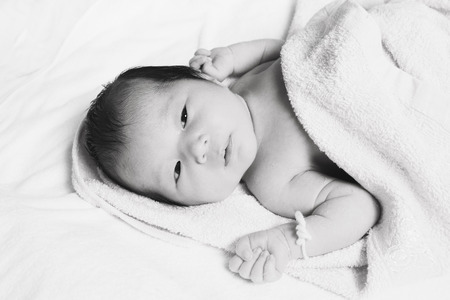 Newborn baby girl with peeling skin (high key selected focus)の写真素材