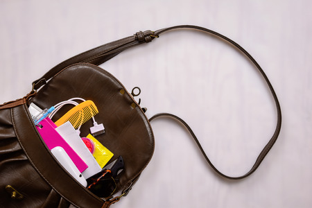 Women bag with, cosmetics  medicine phone and  condom save sex conceptの写真素材