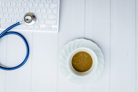 Top view stethoscope on keyboard with coffee concept doctor desk (copy space on right)の写真素材