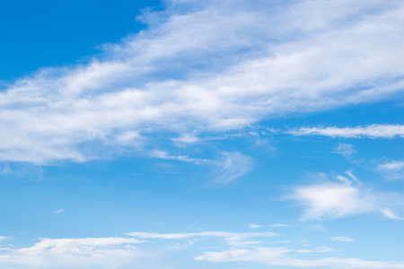 Fantastic soft white clouds against blue sky with copy space for background designの写真素材