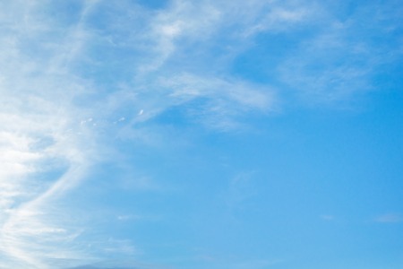 Fantastic soft white clouds against blue sky with copy space for background designの写真素材