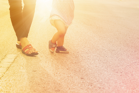 Blurred  of first steps of baby with mother support ,concept for toddler moveの写真素材