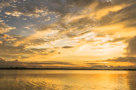 Fantastic fine sunrise sky reflex on the river for nature backgroundの写真素材
