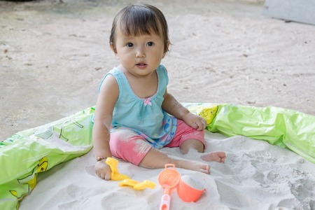 Baby playing toys in sand at home, Sand play is fantastic in aiding a toddler s development and it is such a fun activity to bootの写真素材