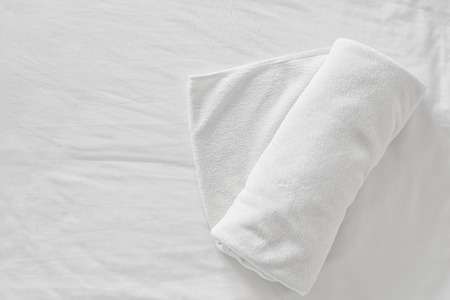 towels on bed sheet decorative at home stayの写真素材