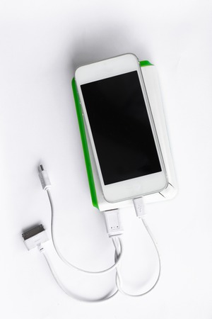 power bank charging power to smart phone on white backgroundの写真素材
