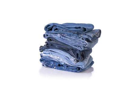 Blue jeans stack on isolate white backgroundの写真素材