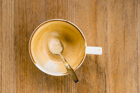 Top view an empty coffee cup on wooden table after drinkingの写真素材