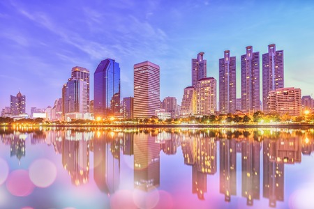 Night cityscape.twilight night view in the business district with bokeh light at from Benjakiti Park at Bangkokの写真素材