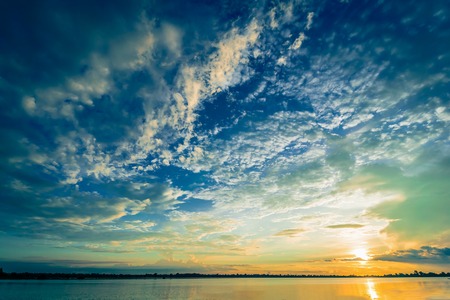 Sunset with blue sky and clouds blue and orange over liver background natureの写真素材