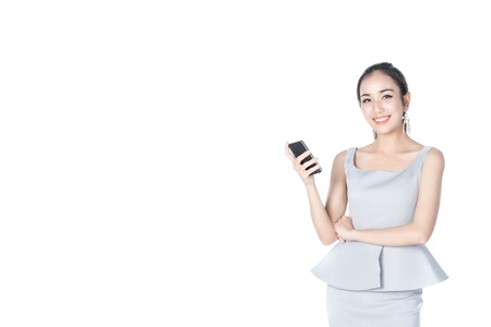 asian businesswoman holding smart phone happy face isolated on a white backgroundの写真素材