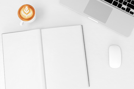 Office desk table with labtop computer,blank magazinesmart phone and coffee cup Top view with copy spaceの写真素材