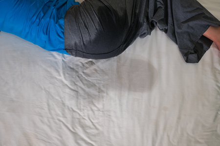Adults pee on a bed mattress,Bedwetting sleep enuresis in Adults ,selected focus at wet on the bedの写真素材