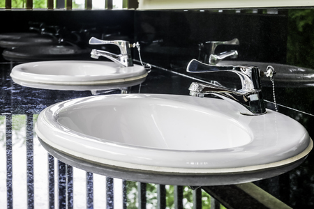 Lavatory sinks in clean public toilet roomの写真素材