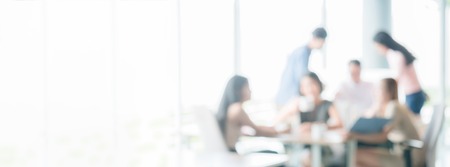 blurred office interior space with business people discussing brainstorming or relaxing background panoramic banner with copy space use us for background backdrop design graphicsの写真素材