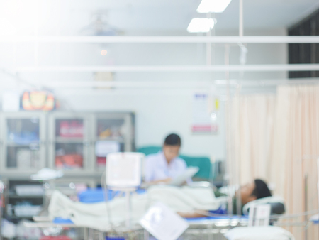 Blurred hospital background -abstract blur Doctors and nurses are busy with the treatment of many sick people in emergency or in patient room background.の写真素材