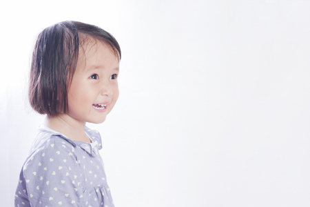 Portrait of 2 year old little girl , Smiling face on bright white background.の写真素材