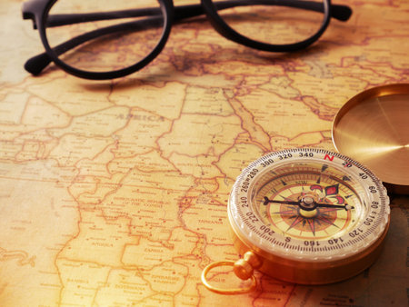 gold vintage compass on vintage map for background