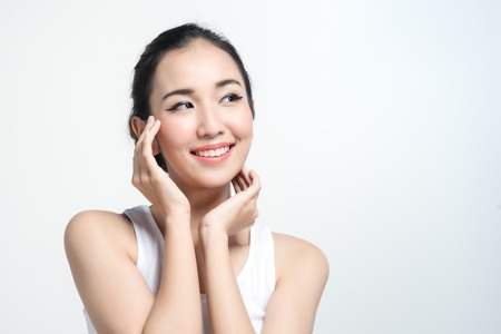 Asian woman with beautiful skinface non make up,pure cosmetic isolated on white backgroundの写真素材