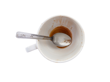 Empty white coffee cup after drink with Sugar at the bottom of the cup on white background - top viewの写真素材