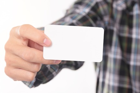 Young Man Takes Out Blank Business Card From The Pocket Of His Shirt For Mock Up Design Templet.の写真素材