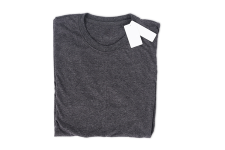 folded t-shirt with tag isolate on white background with clipping path for mockup designの写真素材