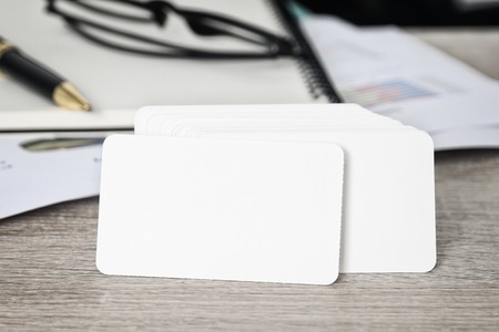 Blank corporate identity business card package on worker table with clipping path on business card for easy design mockup.の写真素材