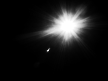 Real sun flare in black background for over lay on designの写真素材