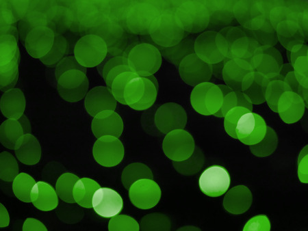 green bokeh lights defocused for design Patricks day backgroundの写真素材