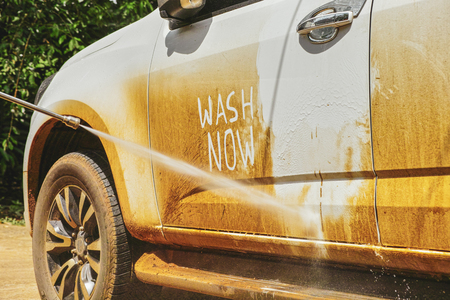 Car Washing with a Water Pressure Cleaner to wash car at homeの写真素材