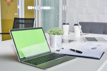 Office workplace with blank screen laptop and office supplies in conference room working spaceの写真素材