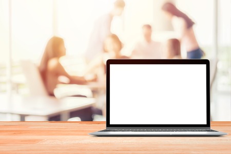 Laptop with blank screen placed on wooden table Blurred people meeting background ,Startup Business plan and discussing concept backgroundの写真素材