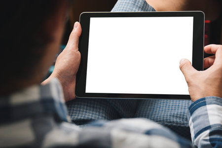 Mockup tablet image, Man using tablet computer while sitting relax on chair with Clipping path on...