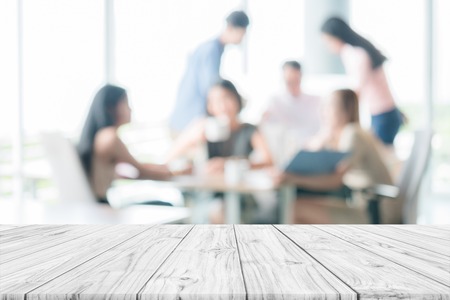 Empty wooden table with people meeting blur background ,can be used for montage or display products design backdropの写真素材