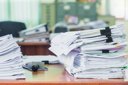 Heap of papers work stack documents on office desk ,business documents billing and examination to report the summary results annual report for presented. Business offices conceptの写真素材
