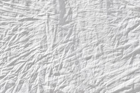 Wrinkled white fabic texture cloth texture ,Soft focus white fabic crumpled from bedding sheet use us backgroundの写真素材
